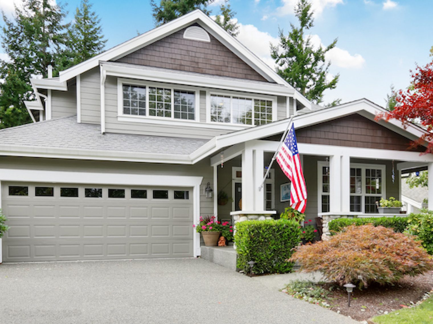 A suburban home with an american flag out front.