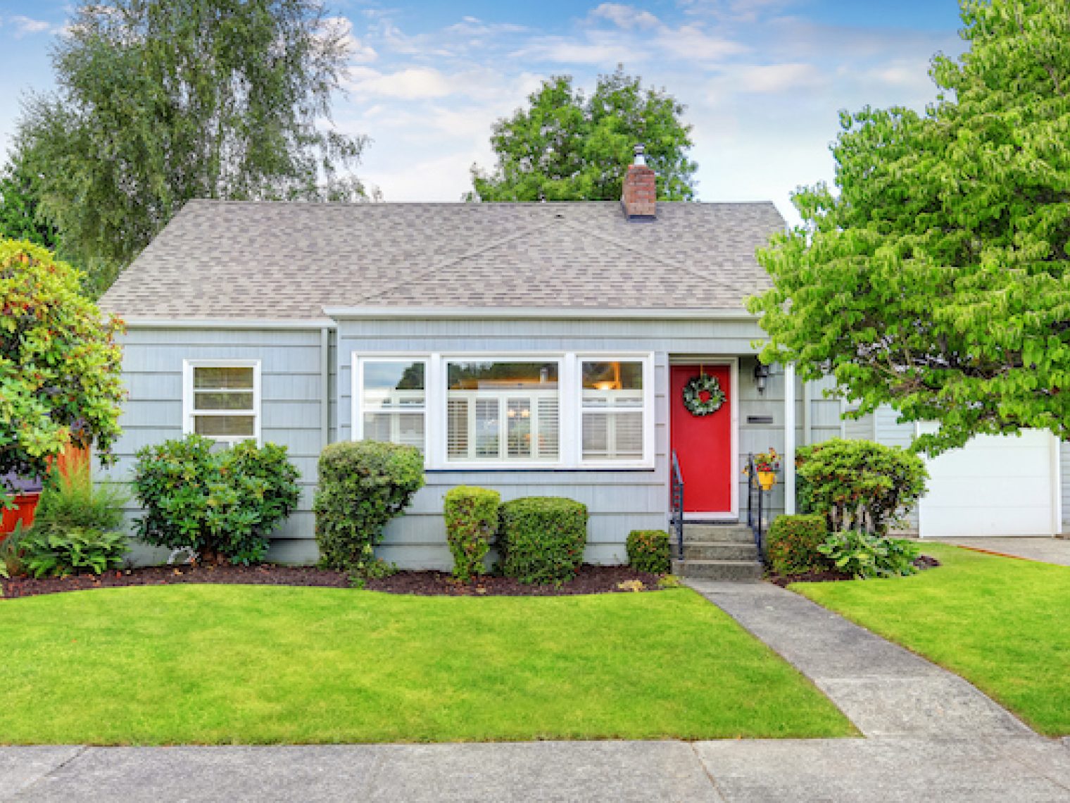 Exterior of small American house with blue paint.