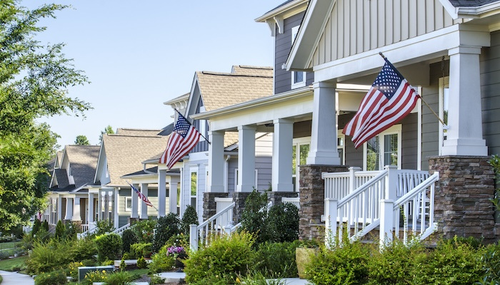 Street of houses displaying American flags.