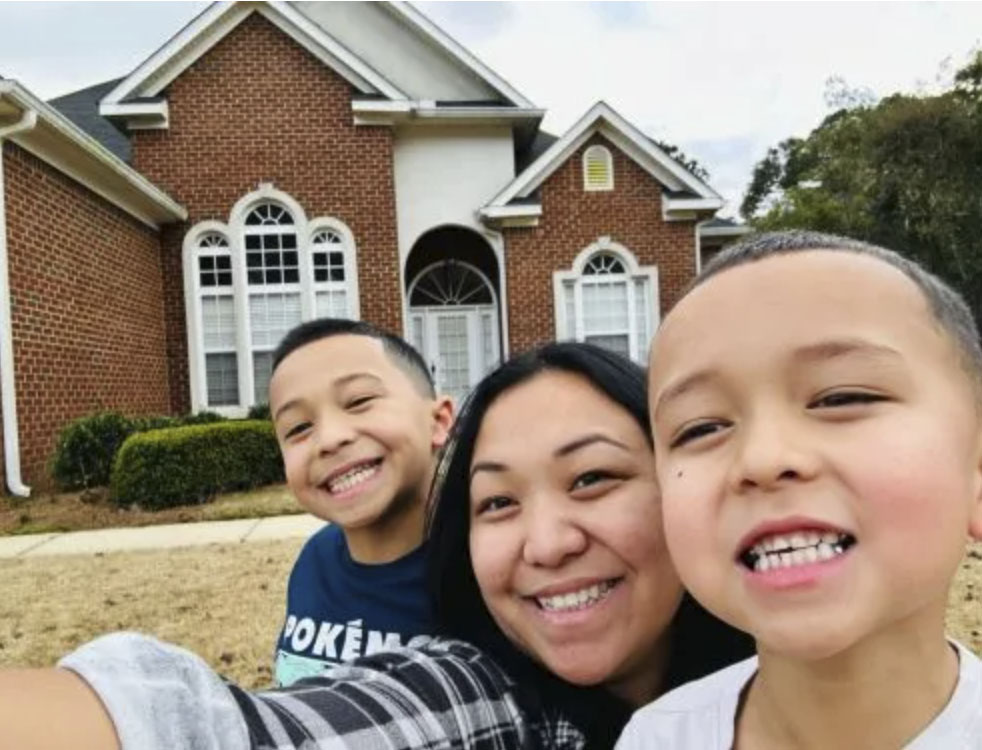 picture of Jodeen B. in front of a house